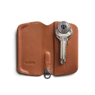 Bellroy Key Cover Third Edition in brown leather holding a single silver key with embossed logo