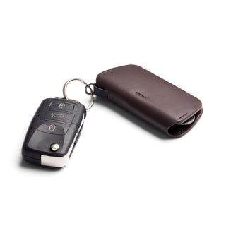 Bellroy Key Cover Third Edition in dark brown leather protecting a modern car key with metal ring