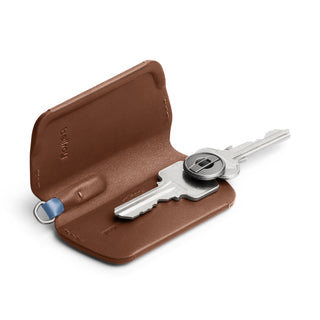 Bellroy Key Cover Third Edition in brown leather holding two silver keys with compact fold design