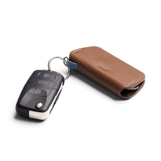 Bellroy Key Cover Third Edition in brown leather attached to black car key fob on white background