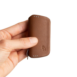 Bellroy Key Cover Third Edition in tan leather held in hand showing compact design and texture