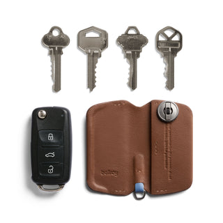 Bellroy Key Cover Third Edition in brown leather with key fob and four silver keys displayed
