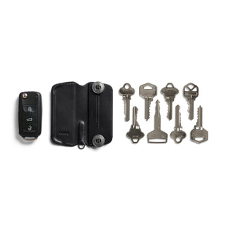 Bellroy Key Cover Plus Third Edition in black leather with keys and car remote beside it