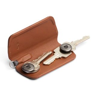 Bellroy Key Cover Plus Third Edition in brown leather with two attached keys lying open on a white background
