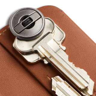 Bellroy Key Cover Plus Third Edition in brown leather holding two silver keys with metal fastener visible