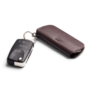 Bellroy Key Cover Plus Third Edition in brown leather with attached car key against white background