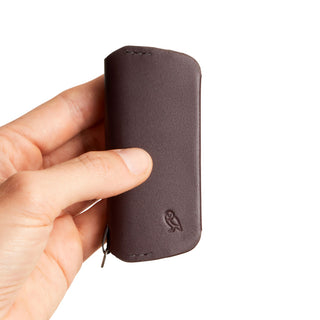 Bellroy Key Cover Plus Third Edition held in hand showing smooth brown leather with embossed owl logo