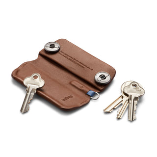 Bellroy Key Cover Plus Third Edition in brown leather with keys attached, laid flat on white background