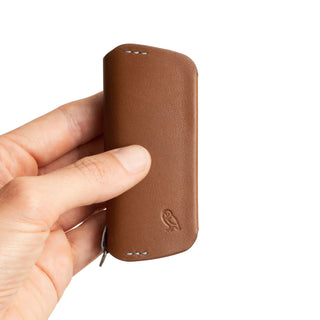 Bellroy Key Cover Plus Third Edition in brown leather held in hand showing compact smooth texture