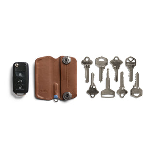 Bellroy Key Cover Plus Third Edition in brown leather with keys and black car key fob beside it