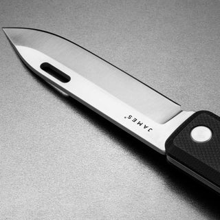 James The Ellis Slim Knife with sleek Sandvik steel blade and textured black G10 handle closeup