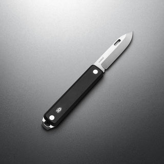 James The Ellis Slim Knife with black G10 handle and sleek stainless steel blade lying flat