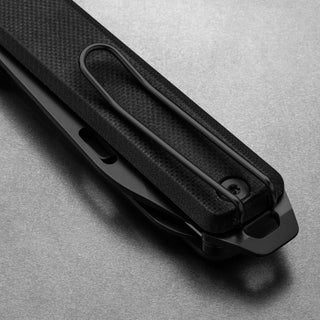 James The Ellis Scissors Knife close-up showing black G10 handle with textured grip and pocket clip