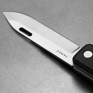 James The Ellis Scissors Knife with polished Sandvik 12C27 steel blade and black textured handle close-up
