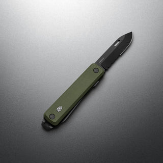 James The Ellis Scissors Knife with green G10 handle and black Sandvik 12C27 steel blade angled on gray background