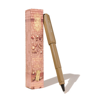 The Roundabout Rollerball Pen | Ferris Wheel Press in matte tan with angular cap and black tip next to branded box