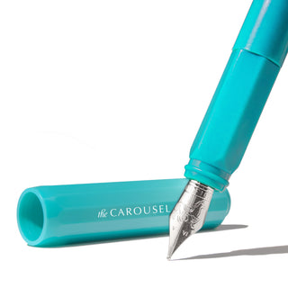 The Carousel Fountain Pen - Tumultuous Tides | Ferris Wheel Press turquoise pen with silver nib and cap on white background