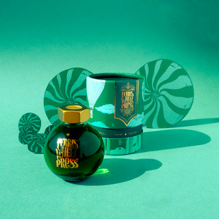Peppermint Drop | 85ml Ink | Ferris Wheel Press green glass bottle with gold cap and decorative packaging on teal background