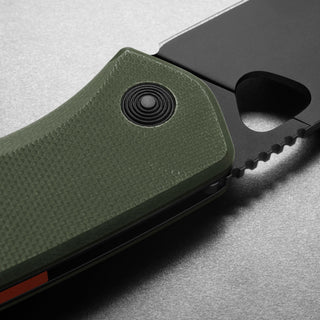 James The Folsom Knife with textured green G10 handle and partially serrated black blade close-up angle