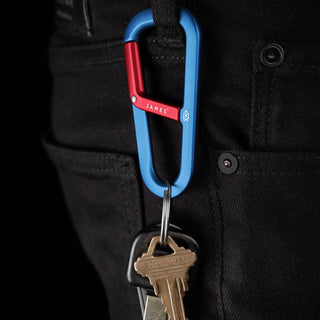 James The Hardin Carabiner in red and blue anodized aluminum holding keys on black pants loop