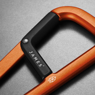 James The Hardin Carabiner by The James Brand in anodized orange aluminum with black latch close-up detail