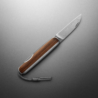 James The Pike Knife with rosewood handle and patterned blade by The James Brand on gray background