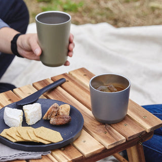 KINTO To Go Tumbler (with plug) 360ml in olive green held, gray tumbler on wooden table outdoors
