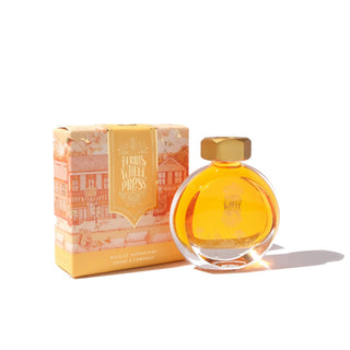 Main St. Marmalade | 38ml Ink | Ferris Wheel Press round glass bottle with amber ink beside illustrated box packaging