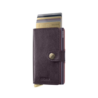 Secrid Miniwallet Basco in dark brown vegetable-tanned leather with cards partially extended and snap closure.