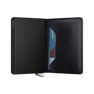 Secrid Slimwallet Basco open showing black vegetable-tanned leather with card partially visible inside