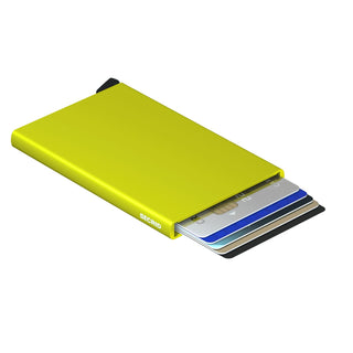 Secrid Cardprotector in bright lime green anodised aluminium holding multiple credit cards fanned out