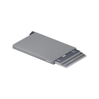 Secrid Cardprotector Powder wallet in matte grey anodised aluminium showing partially ejected cards