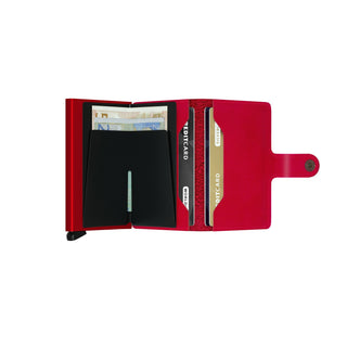 Secrid Miniwallet Original in red European cowhide open showing card slots and banknotes inside