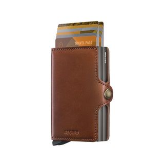 Secrid Twinwallet Texano brown leather wallet with cards partially visible and snap button closure