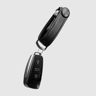 Orbitkey Key Organizer Pro Leather in black with white stitching holding multiple keys and a car key fob