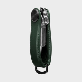 Orbitkey Key Organizer Pro Leather in dark green holding multiple silver keys with black metal loop visible