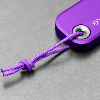 Close-up of purple anodized aluminum handle with lanyard on James The Palmer Knife by The James Brand