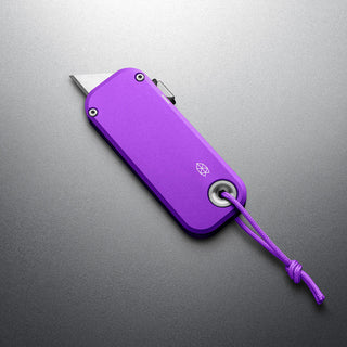 James The Palmer Knife in anodized purple aluminum with compact utility blade and wrist cord loop