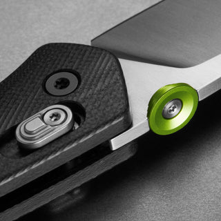 James The Carter Knife close-up showing black Micarta handle and green thumb stud by The James Brand