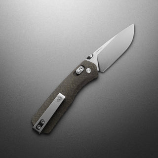 James The Carter Knife with textured Micarta handle and sleek VG-10 steel blade on gray background