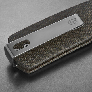James The Carter Knife by The James Brand showing close-up of dark Micarta handle with silver pocket clip