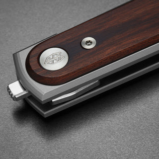 Close-up of James The Duval Knife handle showing rosewood texture and stainless steel frame lock by The James Brand