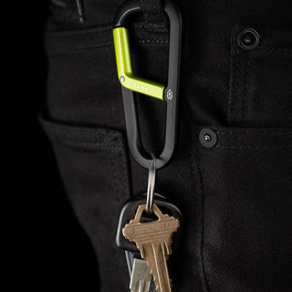 James The Hardin Carabiner in black and green anodized aluminum attached to black pants with keys hanging
