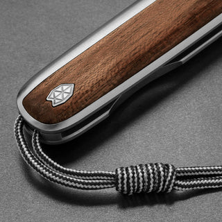 James The Pike Knife with polished rosewood handle and textured black and white lanyard looped through end