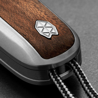 James The Pike Knife close-up on rosewood handle with steel frame and lanyard cord detail