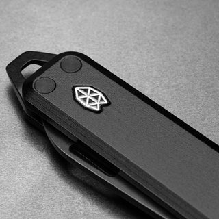 James The Elko Knife closed view showing textured black G10 handle with metal emblem by The James Brand