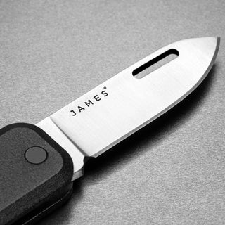 James The Elko Knife close-up showing stainless steel blade with branded engraving and black handle texture