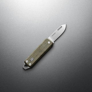James The Elko Knife with textured Micarta handle and sharp stainless steel blade on gray background