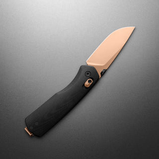 James The Carter Knife with black textured handle and rose gold blade angled on gray background