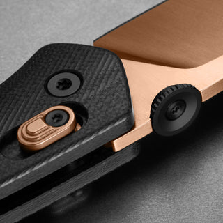 Close-up of James The Carter Knife showing textured Micarta handle and copper-toned blade details by The James Brand